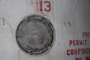 The manhole cover on the interior of the driveway identifies the builder