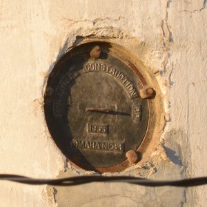The manhole covers display the company name on both the elevator and the annex