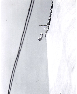 In this 1950 photo from our contributor Neil Lieb's archive, we see a man standing atop a box as it's hoisted to the top of Tillotson Construction Company's newly completed Alta, Iowa, grain elevator. 